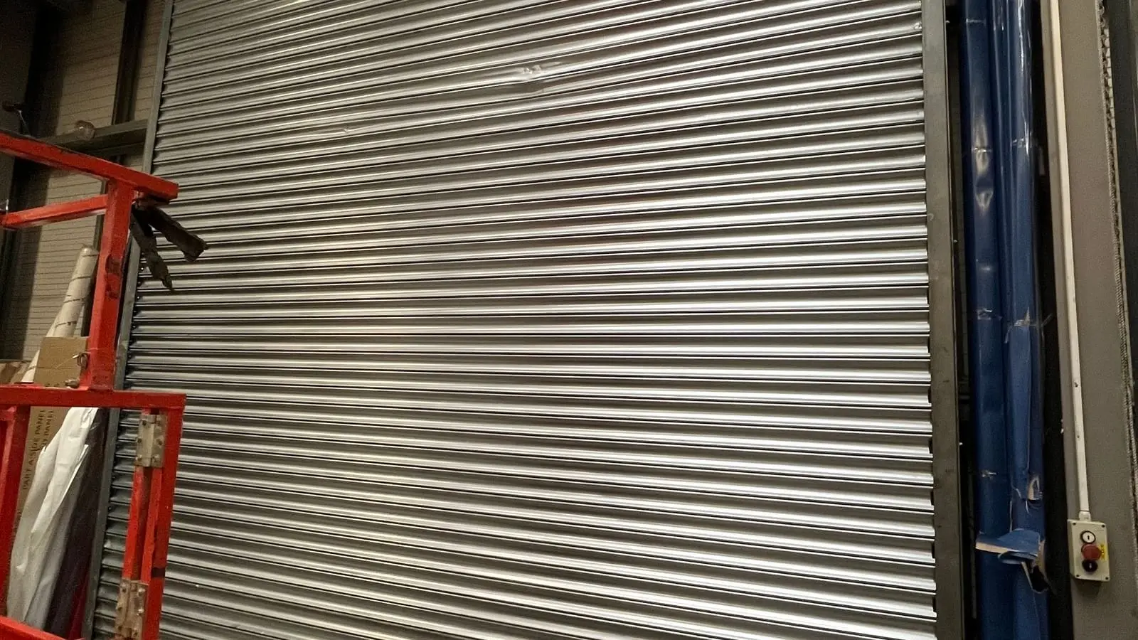 Large steel roller shutter closed inside an industrial unit