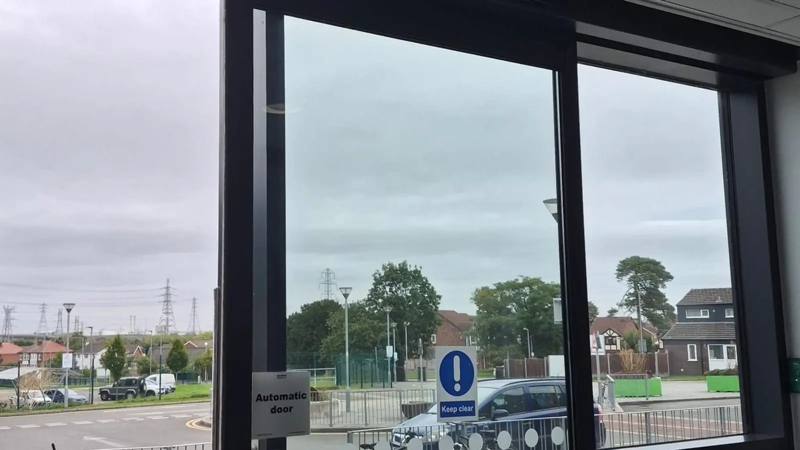 Automatic sliding door with automatic door and keep clear signs, seen from inside